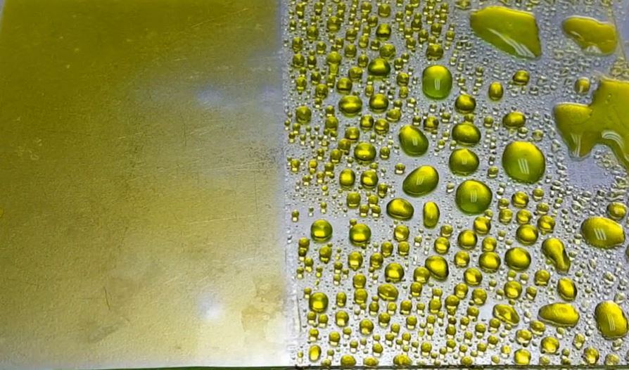 Water beads up on the coated side of a metal panel and soaks into the uncoated side