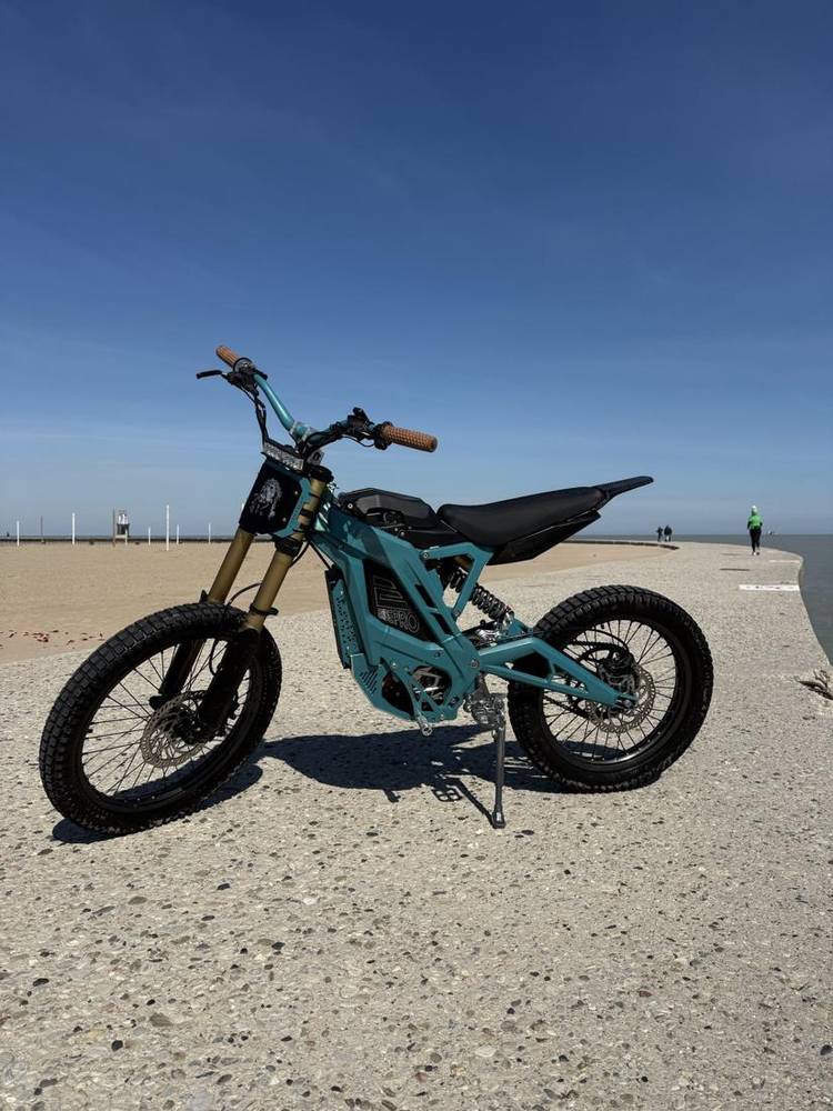 Teal e-bike frame on the lakefront